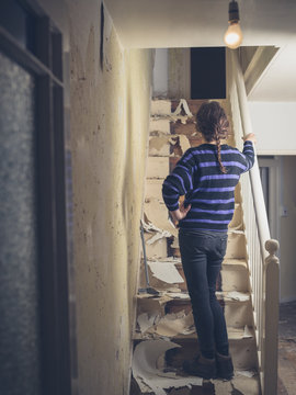 Young woman renovating a staircase