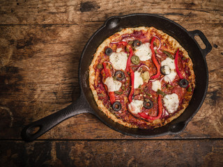 Deep pan pizza on wooden table