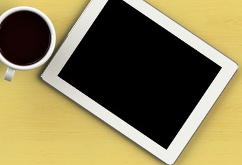 Coffee cup with tablet on yellow wood table
