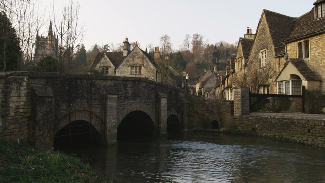 Old stone village a stream and a bridge in England.