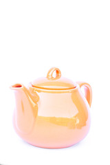 Orange ceramic teapot isolated on white background
