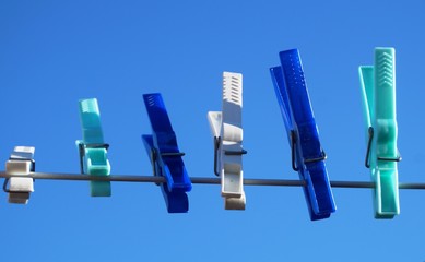 Clothespin on a line with blue sky in the background