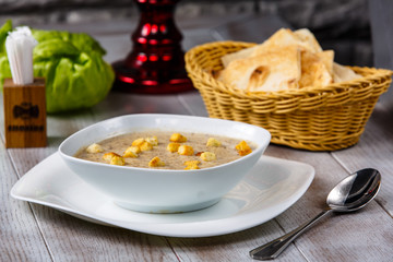 Cream yellow with croutons poured into a plate.