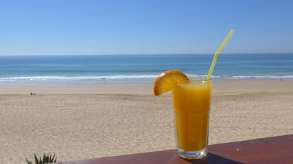 Cool drink at the beach with the ocean in the background