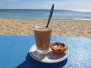 Coffee  at the beach with the ocean in the background