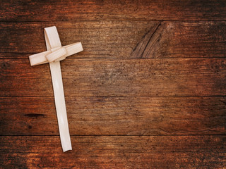 Palm Sunday cross on wooden board. Christian festival.