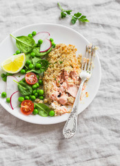 Baked salmon with lemon grain crust and fresh vegetable salad with peas, spinach, radishes and cherry tomatoes. Delicious healthy dinner