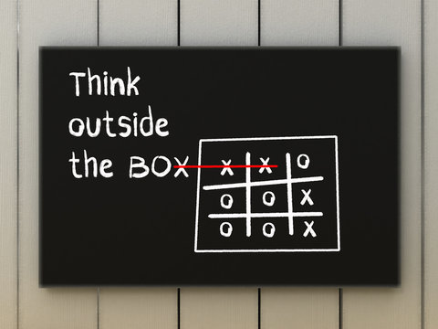 Think outside the box illustration on black board.