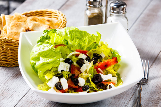Vegetable salad, which is called Greek salad in a white plate