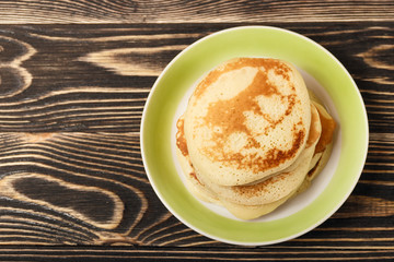 stack of pancakes on wooden board