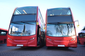 Red double decker buses parked at station