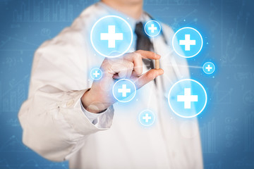 A doctor showing a pill with crosses