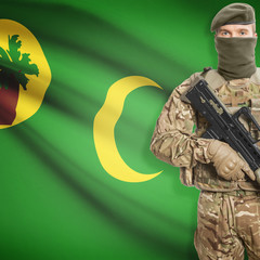Fototapeta premium Soldier with machine gun and flag on background - Cocos (Keeling) Islands