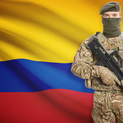Soldier with machine gun and flag on background - Colombia