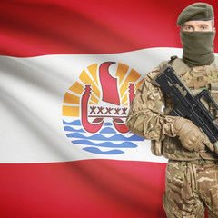 Soldier with machine gun and flag on background - French Polynesia