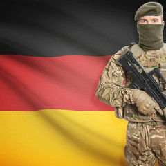 Soldier with machine gun and flag on background - Germany