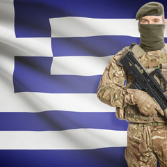 Soldier with machine gun and flag on background - Greece