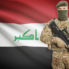 Fototapeta premium Soldier with machine gun and flag on background - Iraq