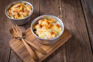 Au Gratin cheese  on the wood table.