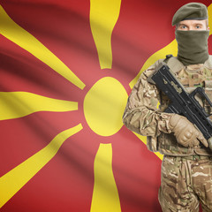 Soldier with machine gun and flag on background - Macedonia