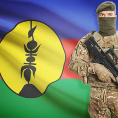 Soldier with machine gun and flag on background - New Caledonia