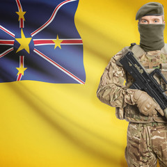 Soldier with machine gun and flag on background - Niue