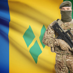 Soldier with machine gun and flag on background - Saint Vincent and the Grenadines