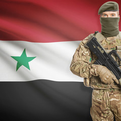 Fototapeta premium Soldier with machine gun and flag on background - Syria