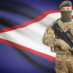 Fototapeta premium Soldier with machine gun and flag on background - American Samoa