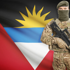 Soldier with machine gun and flag on background - Antigua and Barbuda