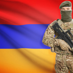 Fototapeta premium Soldier with machine gun and flag on background - Armenia