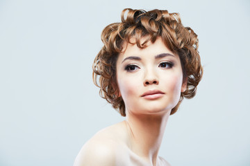 Fototapeta premium Young woman close up face beauty portrait on white background.
