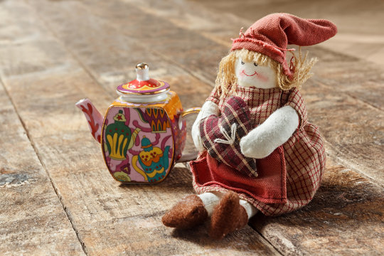Rag dolls and tea on a wooden table