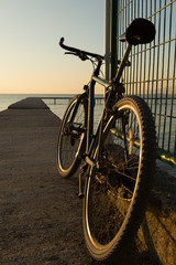 bicycle parked on a pier on Lake Iznik, Turkey at sunset