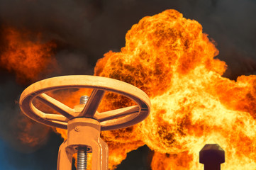 The gas valve on the background of flaming torch flame