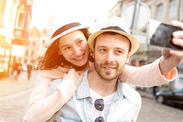 Fototapeta na wymiar Young couple on holidays taking selfie