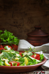Salad with avocado, cherry tomatoes, peppers, cucumbers, herbs,