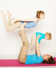 Fototapeta na wymiar mother, father and son doing yoga