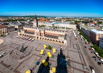 Main Market Square (Rynek), old cloth hall (Sukiennice) and town hall tower in Cracow (Krakow), Poland. Aerial view