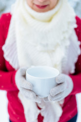 Woman with a cup of tea in the winter outdoors