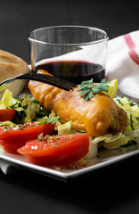 Fried fish with lettuce, lemon and tomato