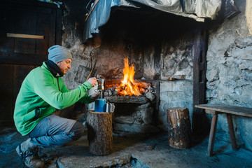 Mountaineer in shelter before the fire