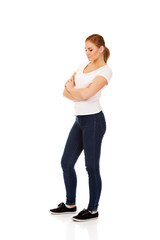Fototapeta premium Worried young woman with folded arms