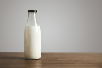 Antic blank bottle with milk on table