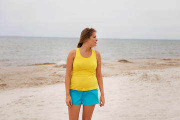 Fototapeta na wymiar Tired woman standing on the beach