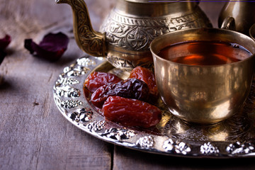 Traditional arabic tea set and dried dates.
