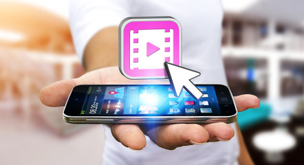 Young man using modern mobile phone to watch video