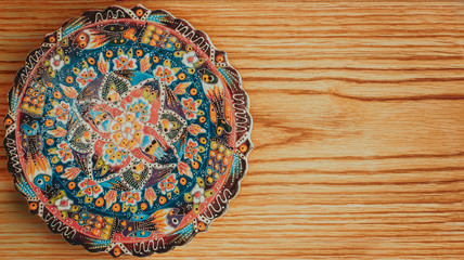 Fototapeta na wymiar Vintage Plate on wooden background, oriental style