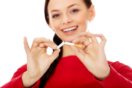 Happy student woman snapping cigarette