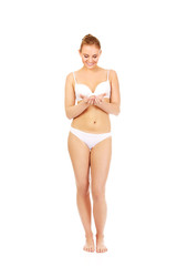 Fototapeta premium Young woman in lingerie holding something on open palms 